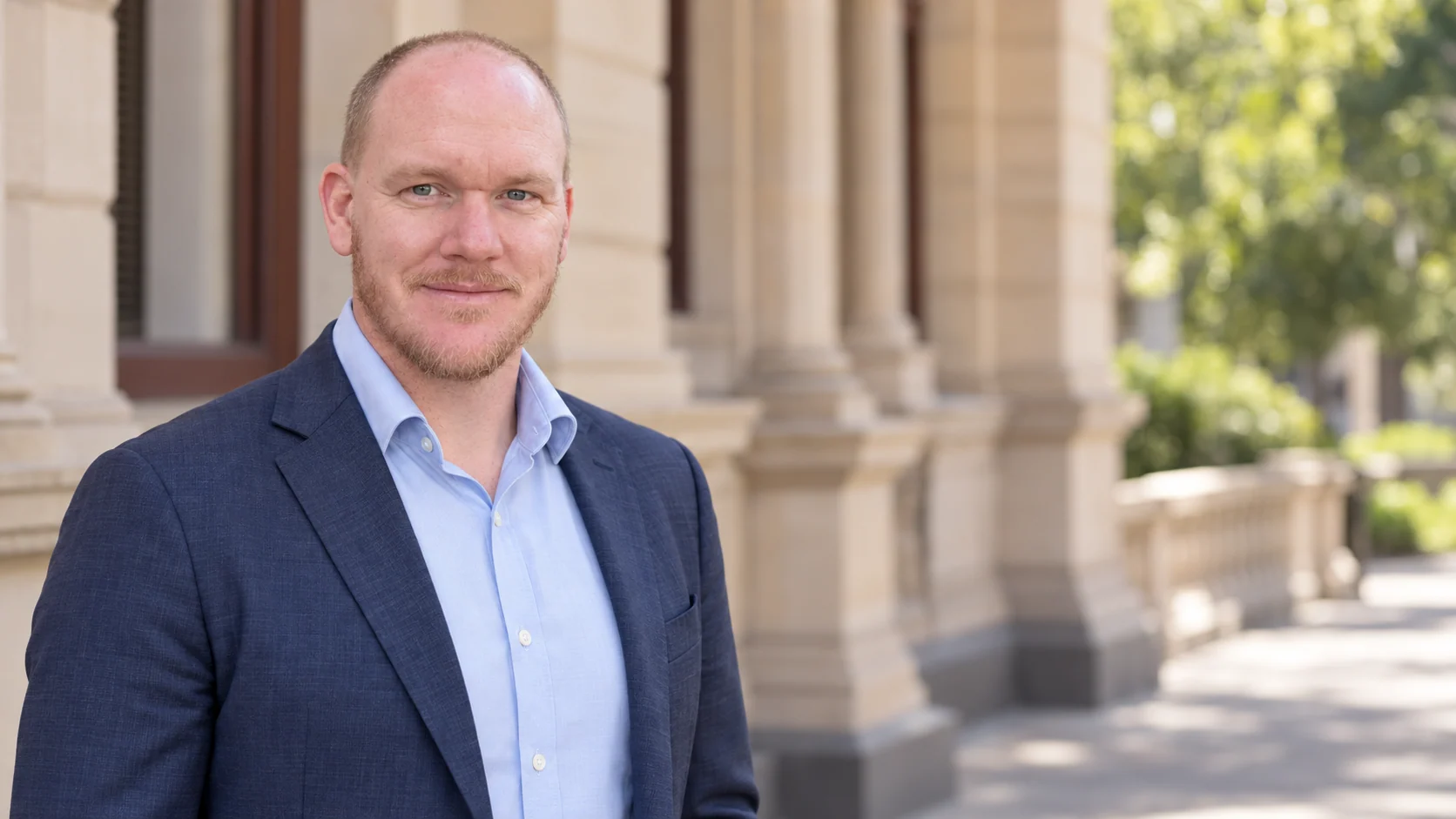 Daniel Brownlie outside a sandstone building